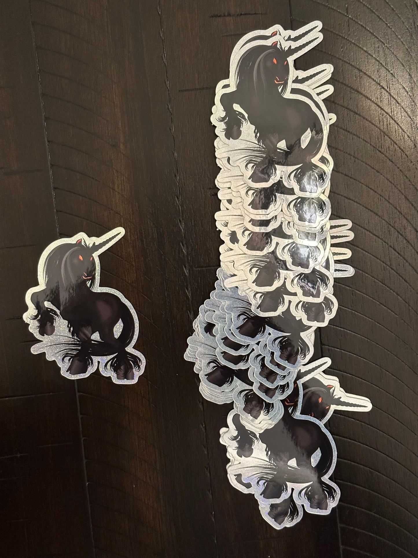 Black Unicorn Sticker with Pixie Dust Texture with glowing orange eyes - Nightmare showing ghoulish eyes and standing on rear hooves