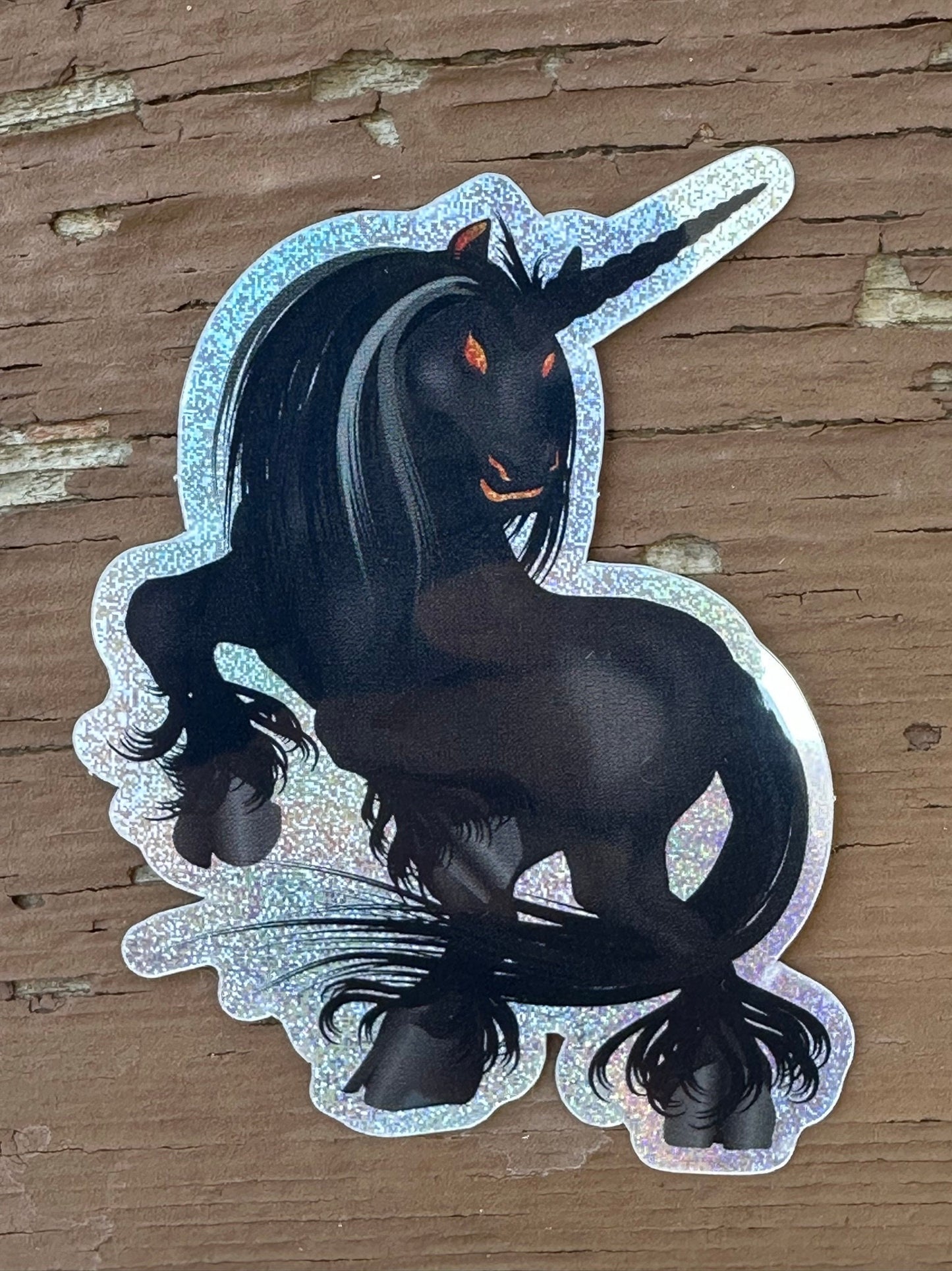 Black Unicorn Sticker with Pixie Dust Texture with glowing orange eyes - Nightmare showing ghoulish eyes and standing on rear hooves