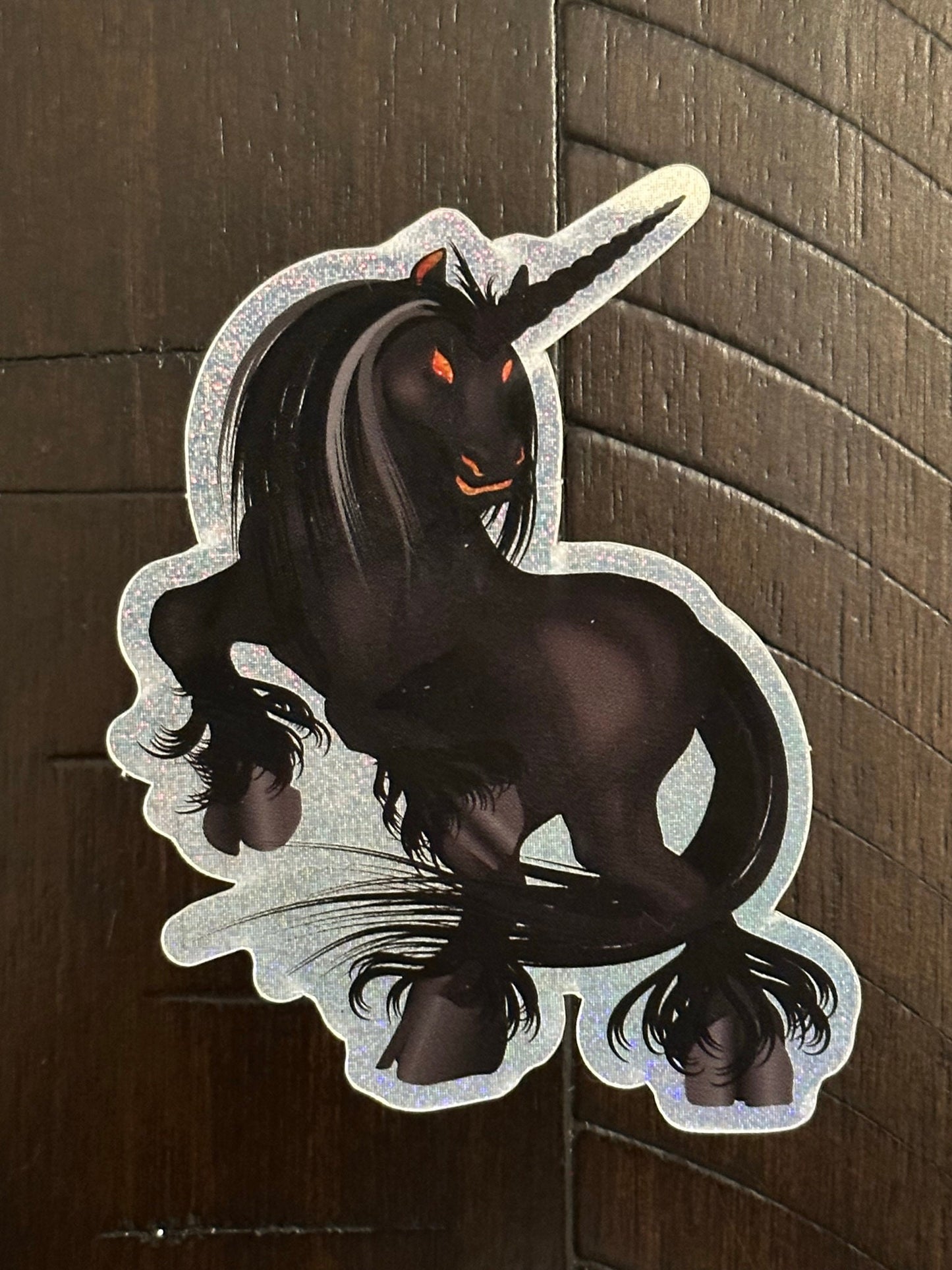 Black Unicorn Sticker with Pixie Dust Texture with glowing orange eyes - Nightmare showing ghoulish eyes and standing on rear hooves