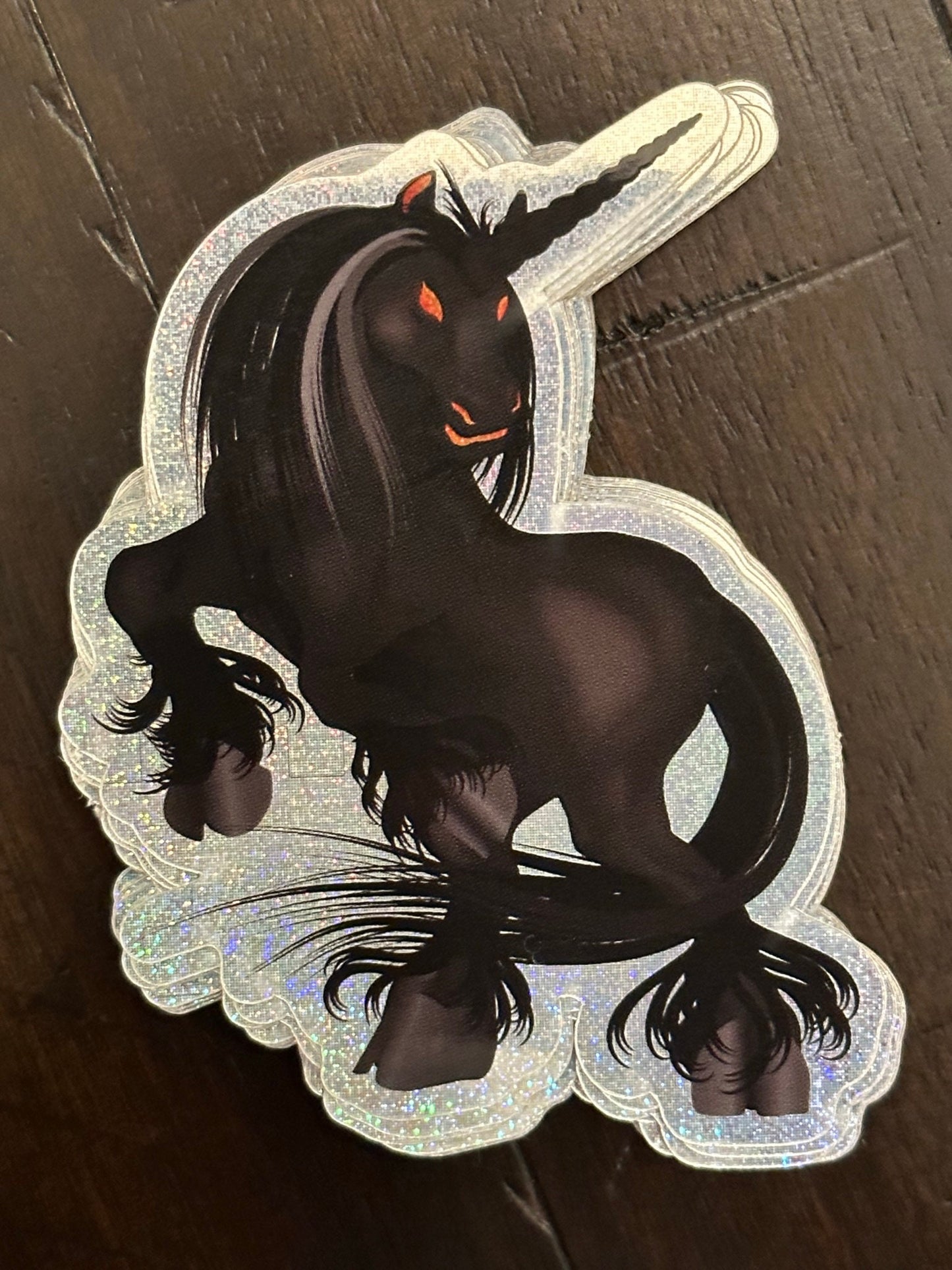 Black Unicorn Sticker with Pixie Dust Texture with glowing orange eyes - Nightmare showing ghoulish eyes and standing on rear hooves