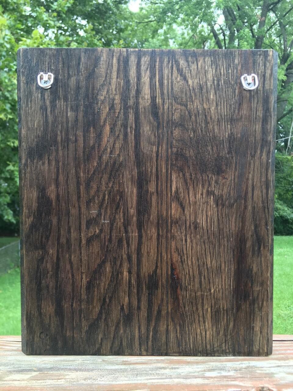 Useless Plaque - a pyrographic piece of oak wood that is stained, and painted with metallic paint and coated with protectant