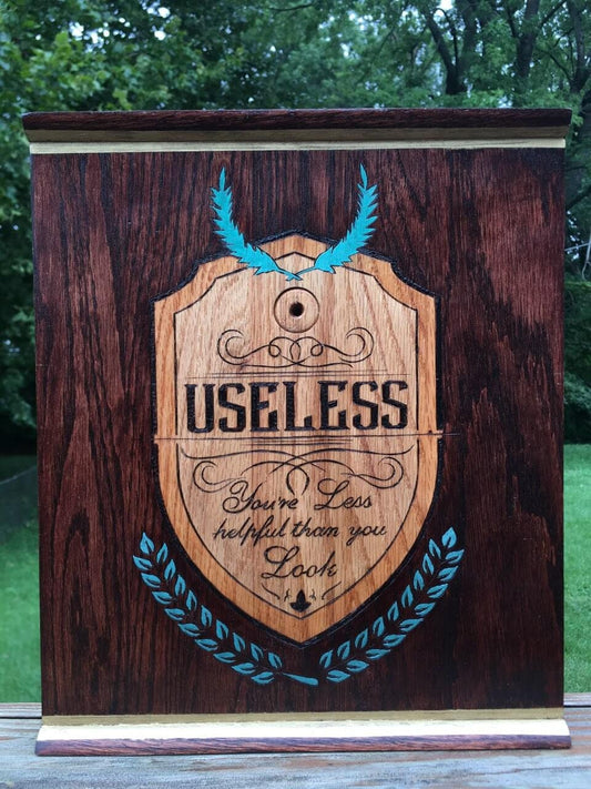 Useless Plaque - a pyrographic piece of oak wood that is stained, and painted with metallic paint and coated with protectant