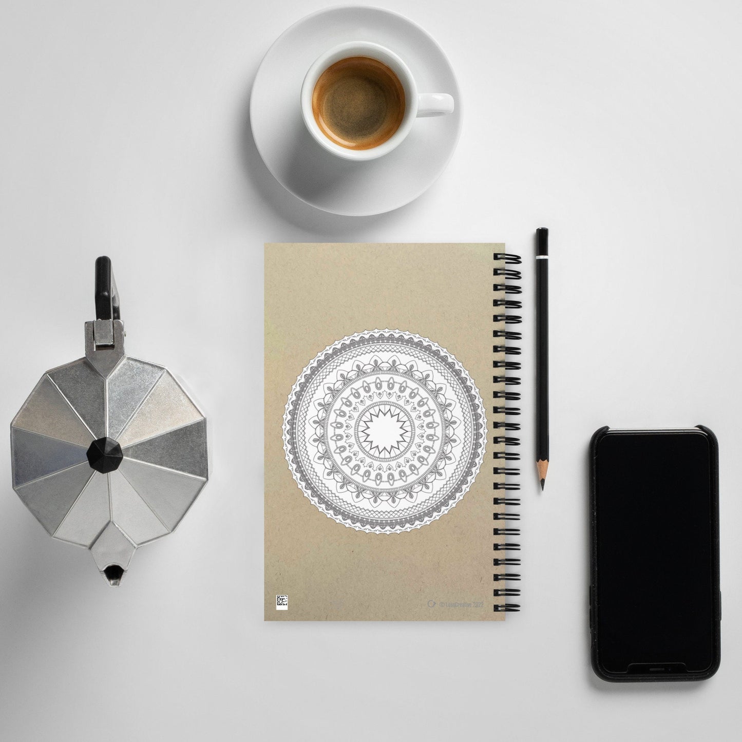 A white blank Mandala Spiral notebook with a brown paper background where you can write notes or make drawing