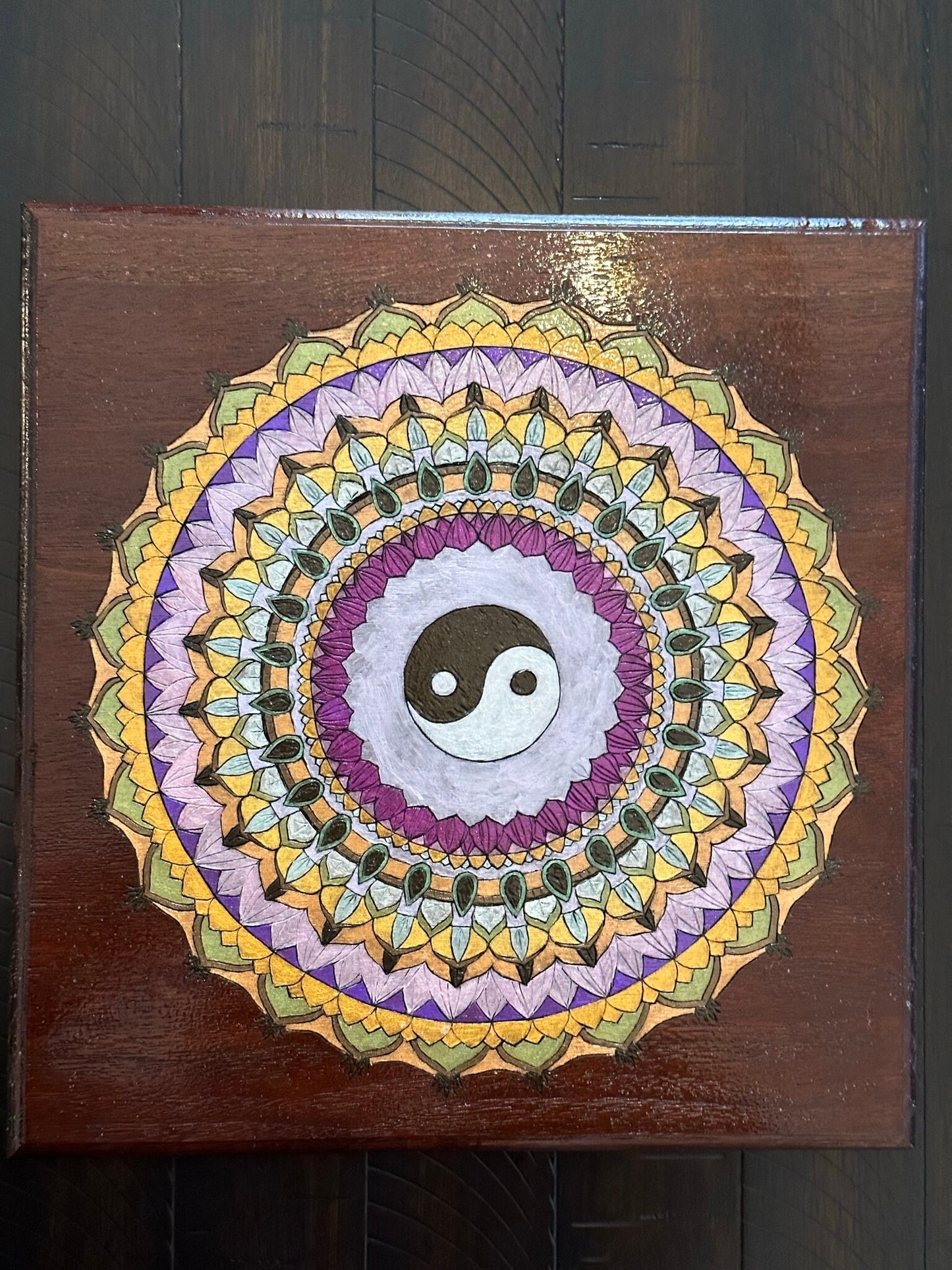 Ying Yang Mandala wood burned on reclaimed bar wood - deep reddish wood stained with a burned sienna colored stain