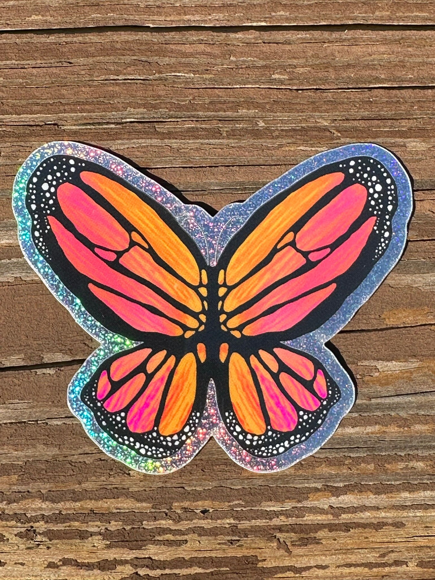Butterfly Sticker - Pixie Dust Sticker of a Monarch Butterfly Electric Orange wings with dots on the ends  showing a multi-colored pattern