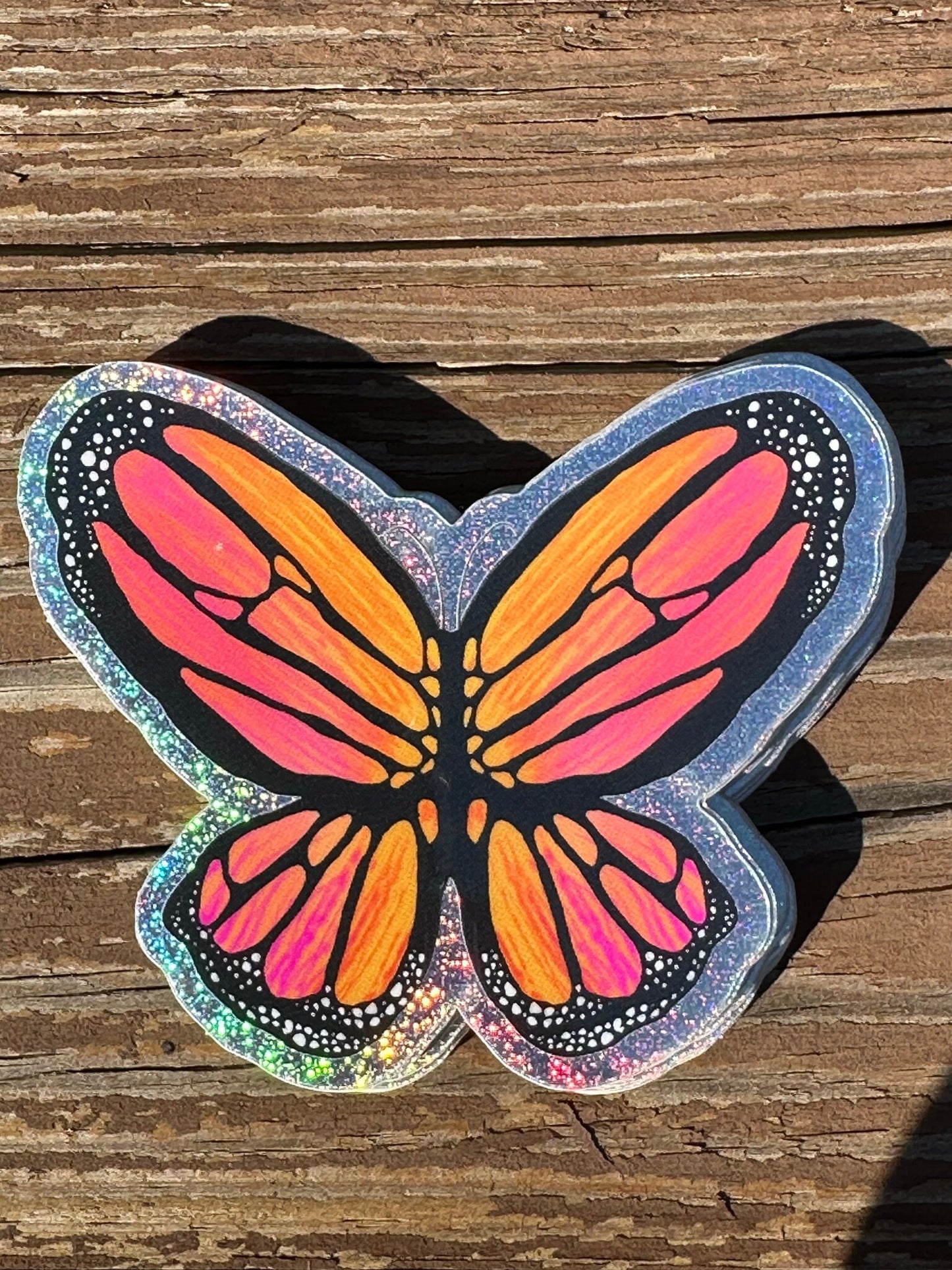 Butterfly Sticker - Pixie Dust Sticker of a Monarch Butterfly Electric Orange wings with dots on the ends  showing a multi-colored pattern